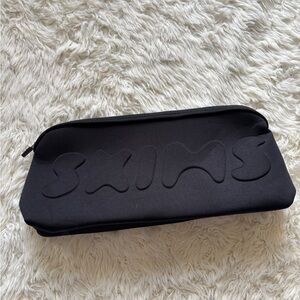 SKIMS Black Embossed Pouch